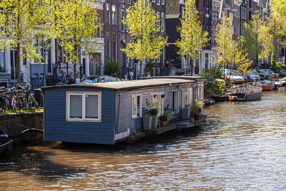 shallow focus photo of blue house near body of water