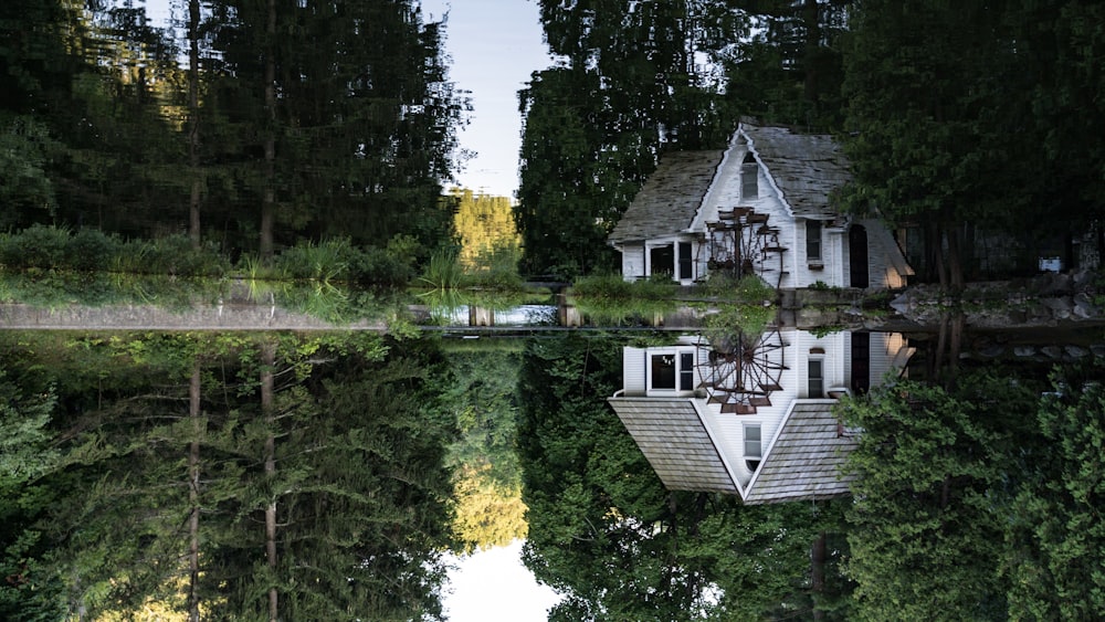 white cabin near green trees during daytime