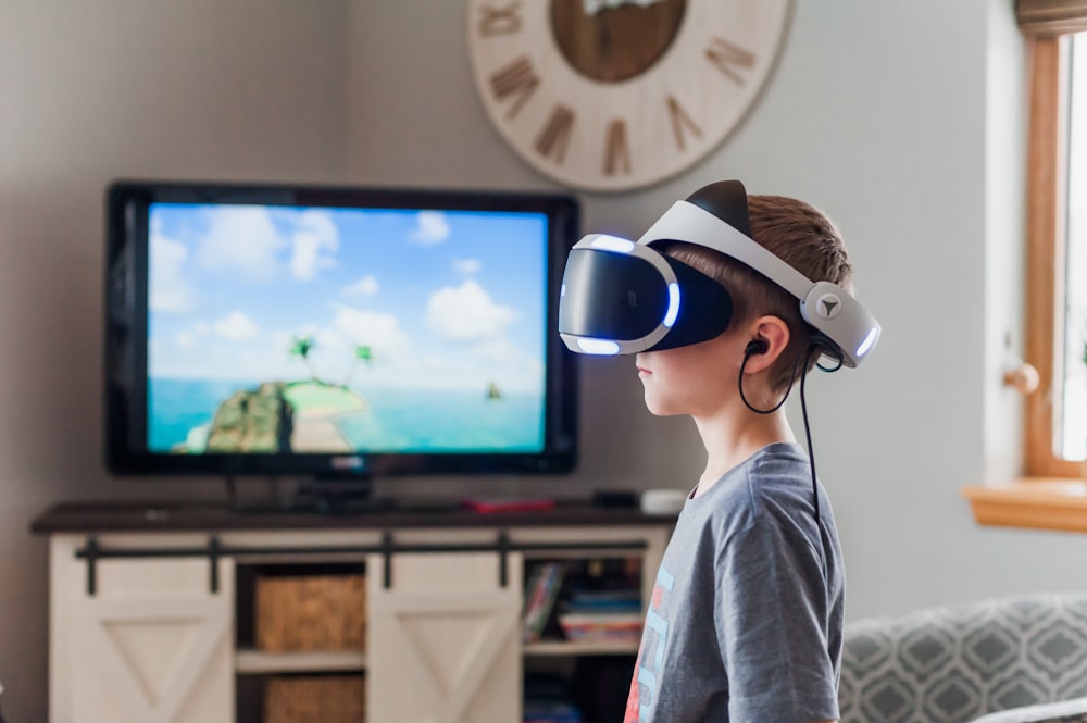 boy wearing black and white VR headset