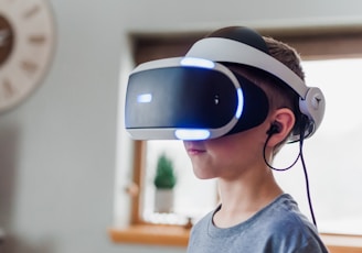 boy wearing black and white VR headset