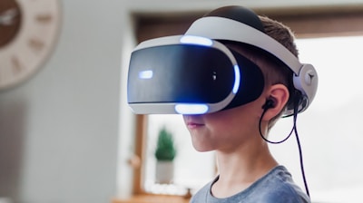 boy wearing black and white VR headset