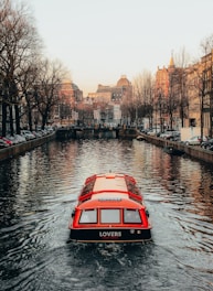 red and black vehicle on body of water