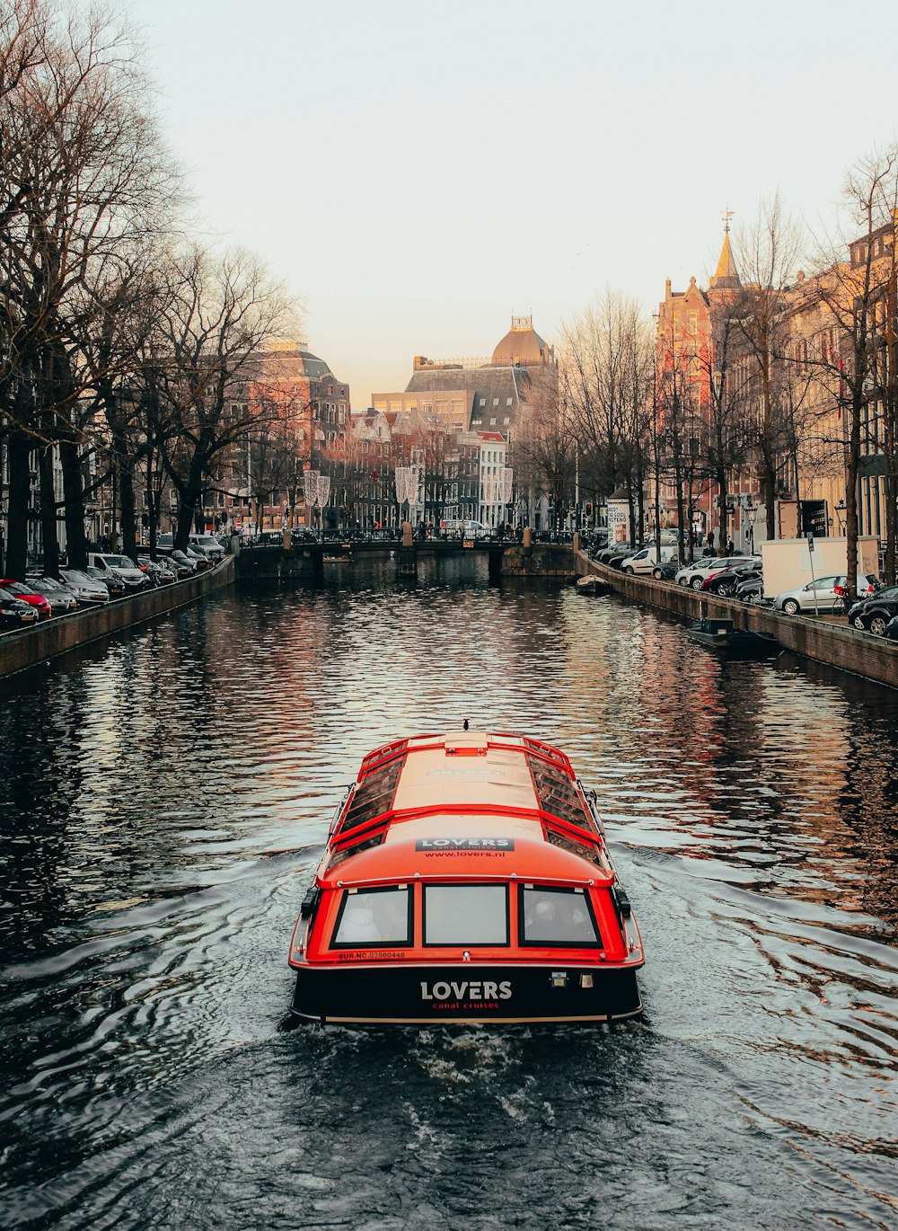 red and black vehicle on body of water