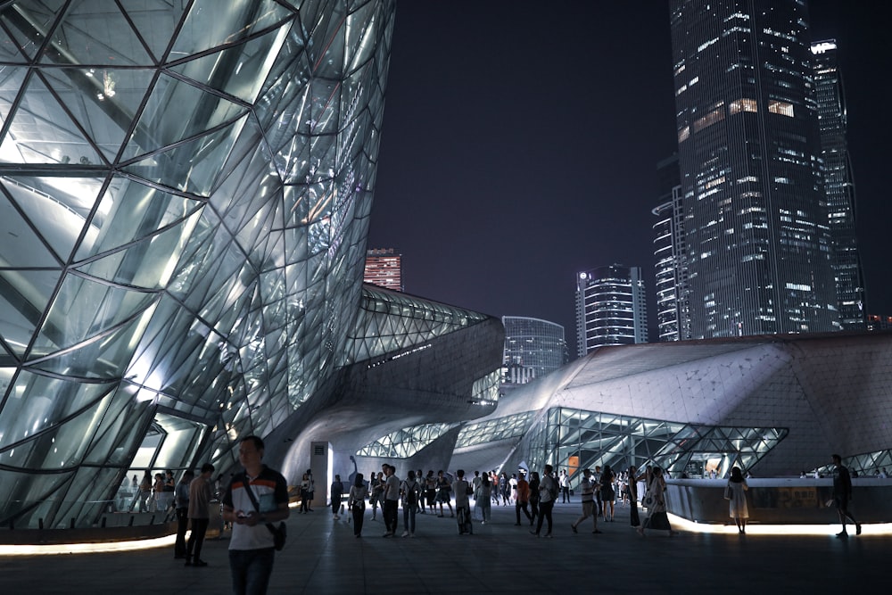 people walking outside a building during nighttime