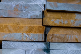 Stack of reclaimed wood planks ready for a new project, showcasing natural textures.