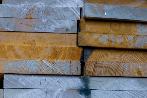 Stack of reclaimed wood planks ready for a new project, showcasing natural textures.