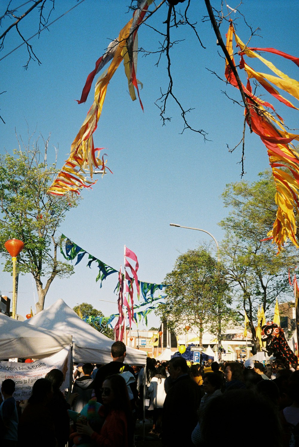 a crowd of people standing around a tent