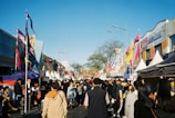 men and women gathered in the street during daytime