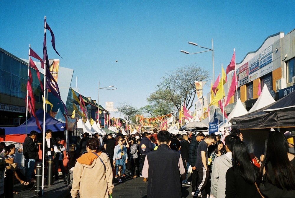 men and women gathered in the street during daytime