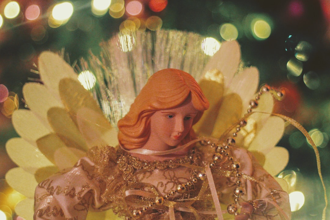 shallow focus photo of angel figurine