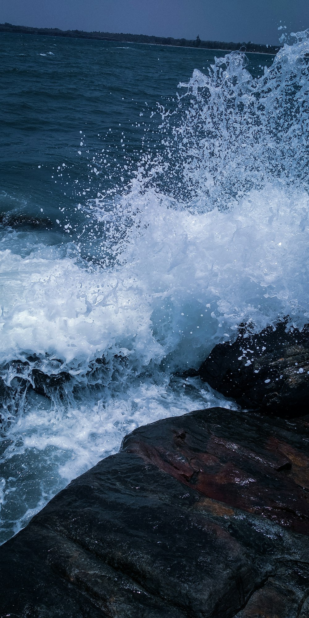 wave of water on rocks