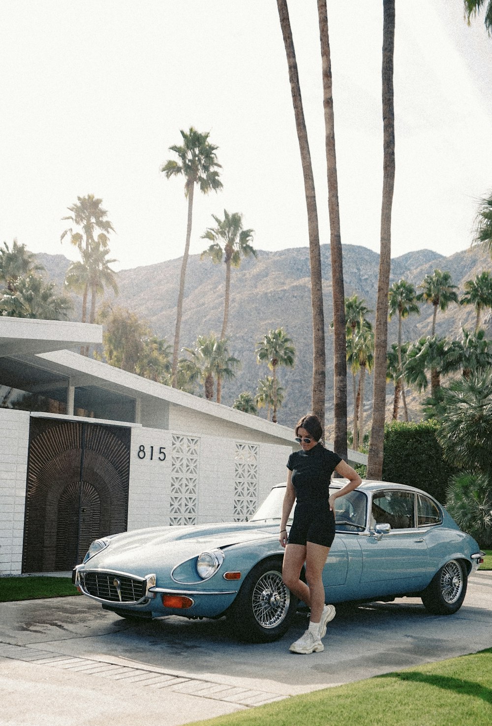 woman near blue coupe