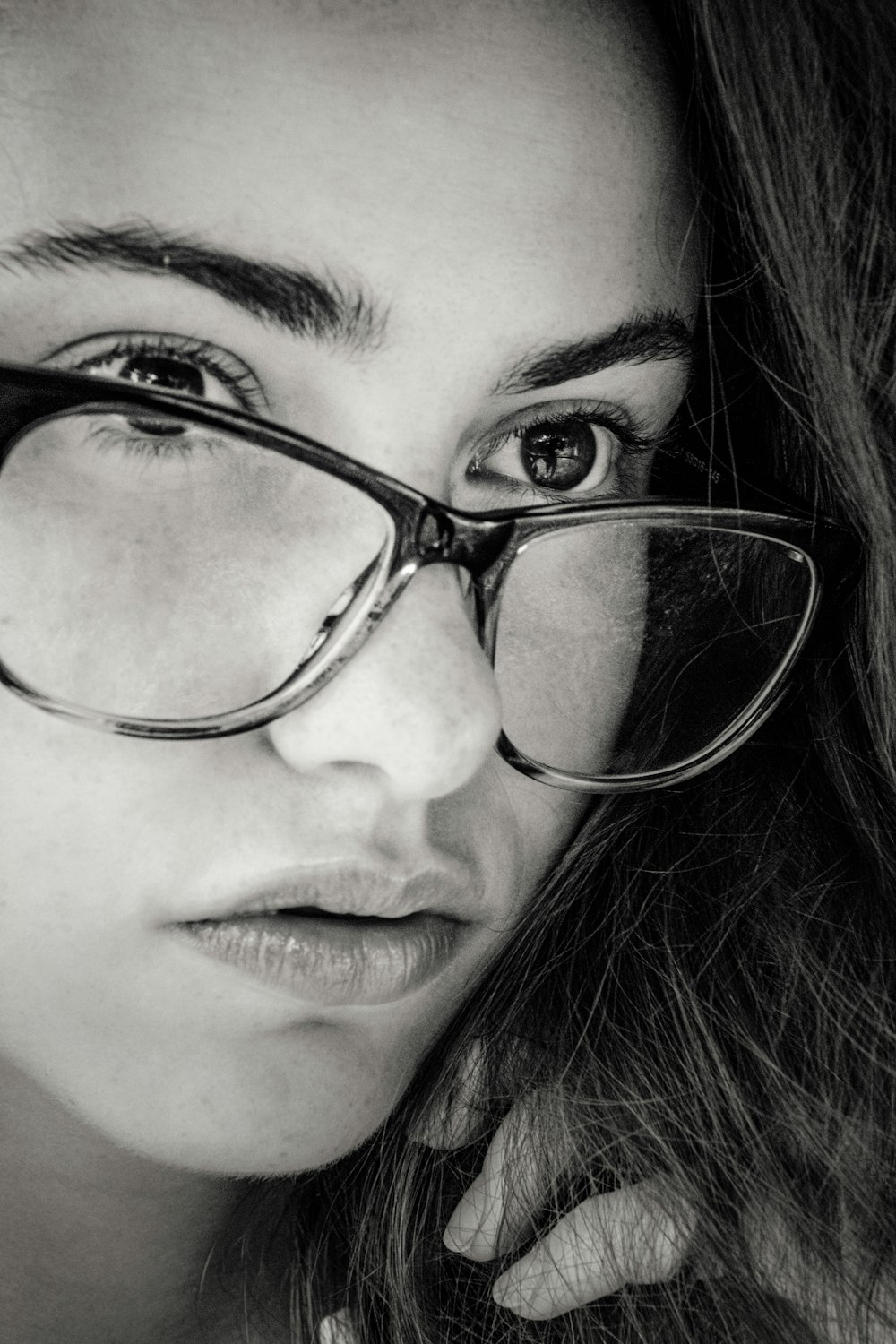 woman wearing eyeglasses grayscale photo