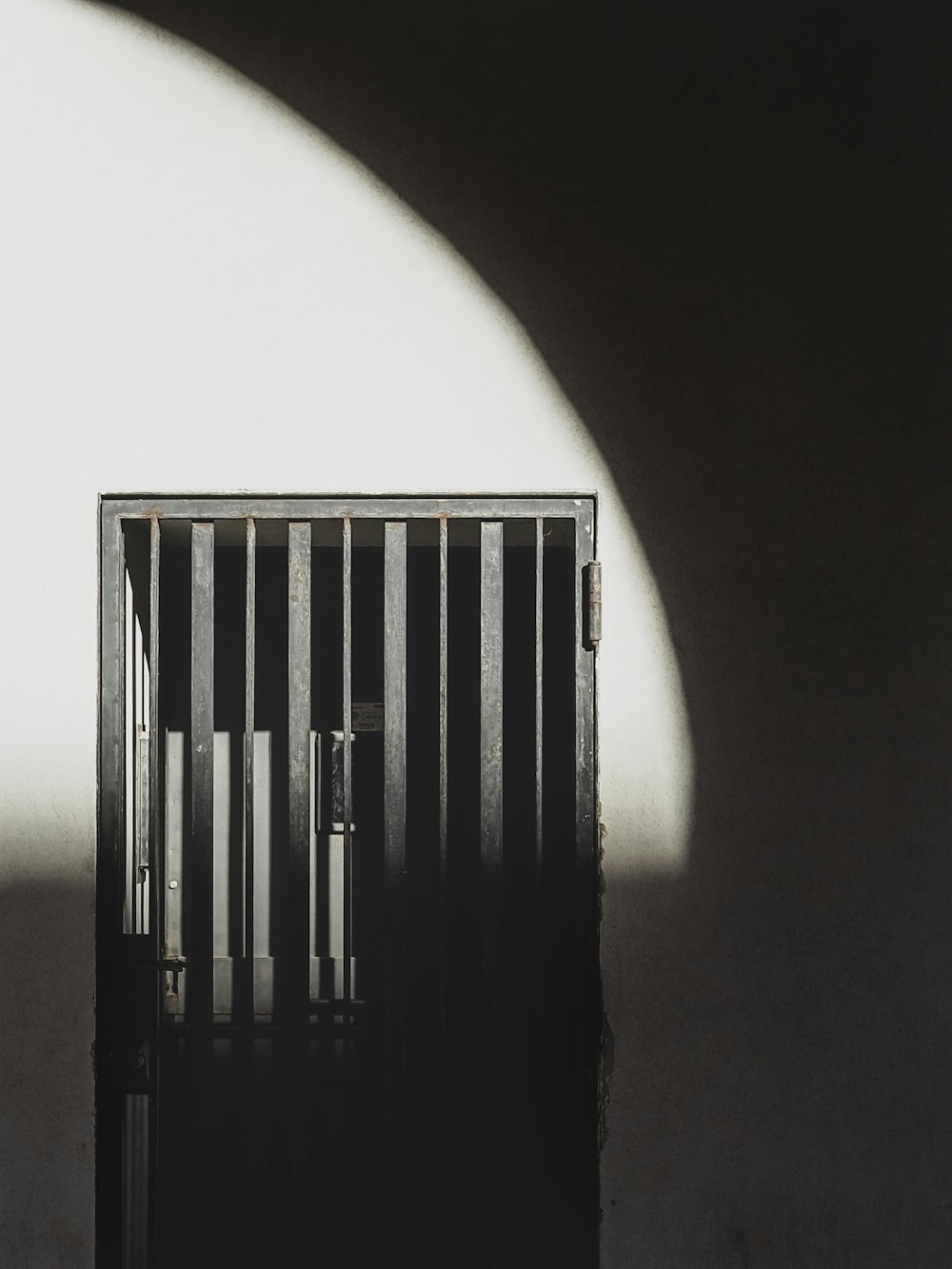 a black and white photo of a jail cell