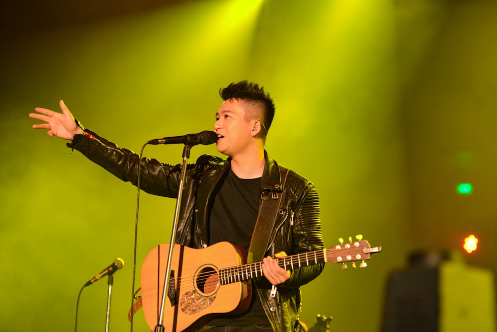 man with guitar on stage