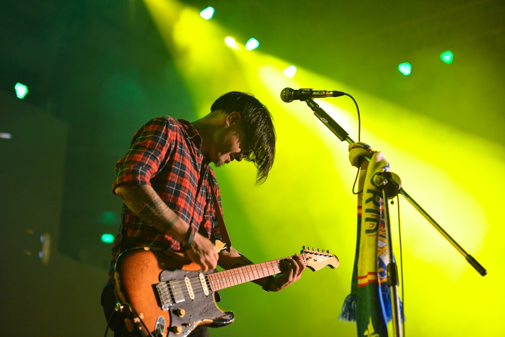 man with guitar on stage