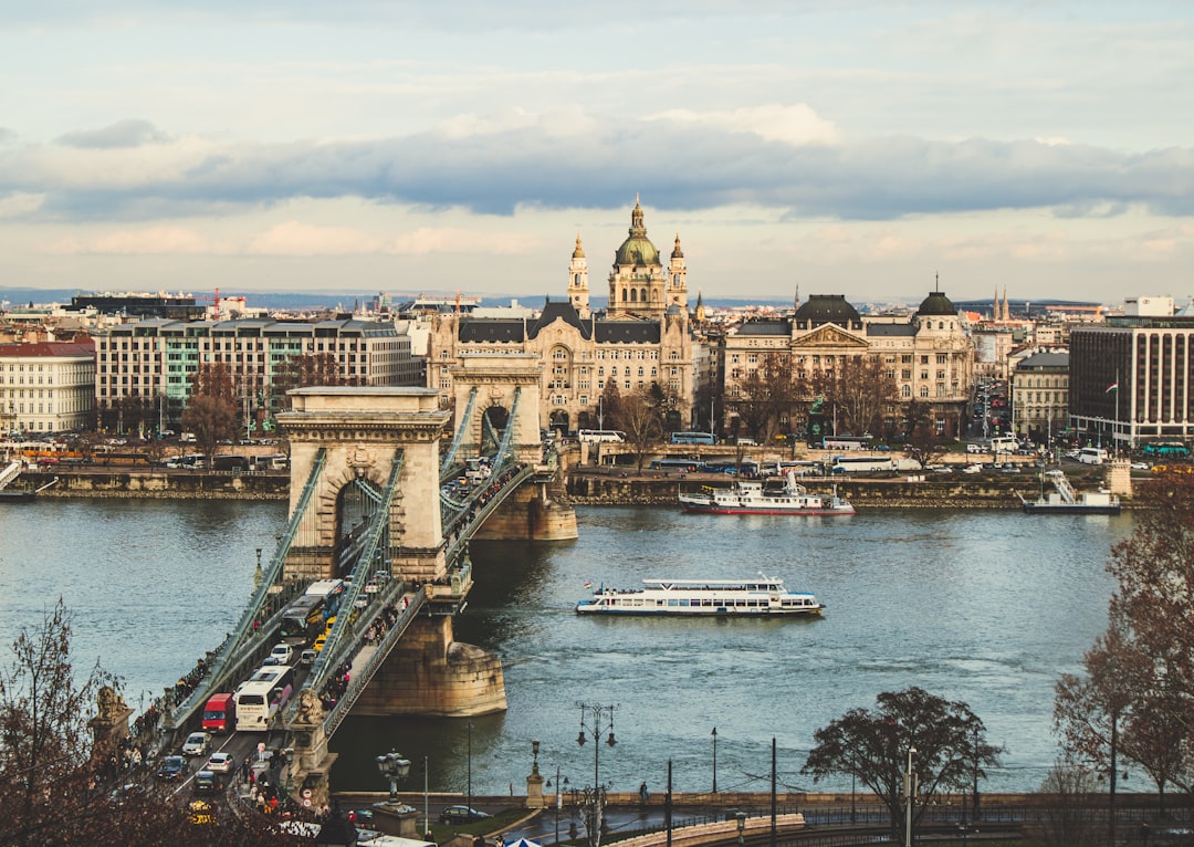 bridge over body of water in front of buildings,