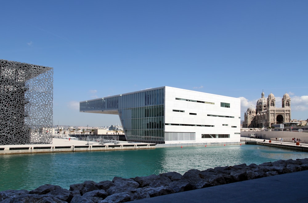 white concrete building under a calm blue sky