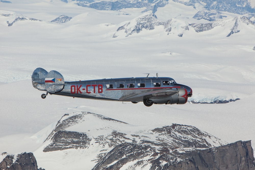 gray OK-CTB airplane ove snow mountain
