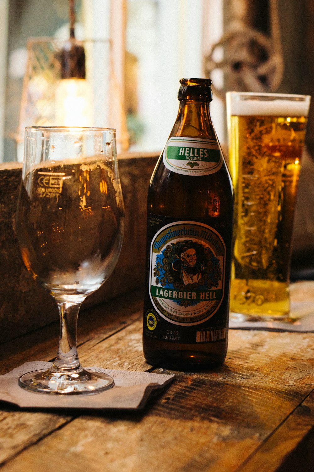 clear wine bottle beside brown glass bottle