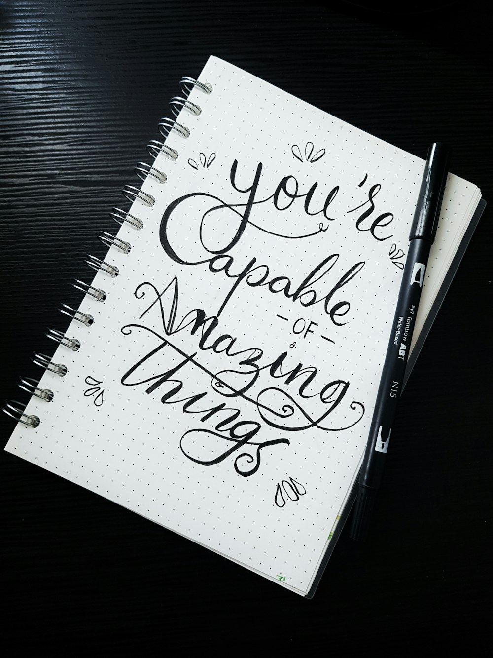 Pen on You're able of amazing things spiral notebook