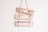 Three wooden signs are stacked vertically, each with a word painted in white. The words are 'LIVE', 'LAUGH', and 'SURF'. These signs are hanging on a wall and are connected by a rope.