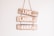 Three wooden signs are stacked vertically, each with a word painted in white. The words are 'LIVE', 'LAUGH', and 'SURF'. These signs are hanging on a wall and are connected by a rope.