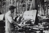 man standing infront of mechanical machine