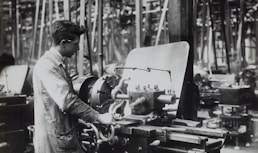 man standing infront of mechanical machine