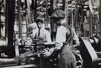 grayscale photo of man doing mechanical work