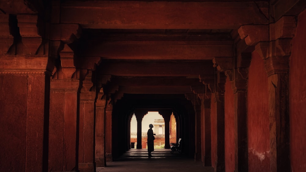 silhouette of person standing under hallway