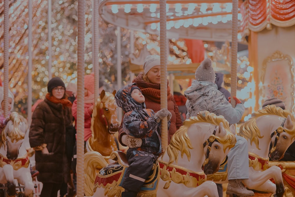 children riding carousel