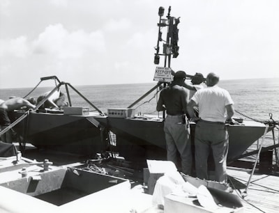 Technician adjusting the VMS (Vessel Monitoring System) aboard a marine vessel.