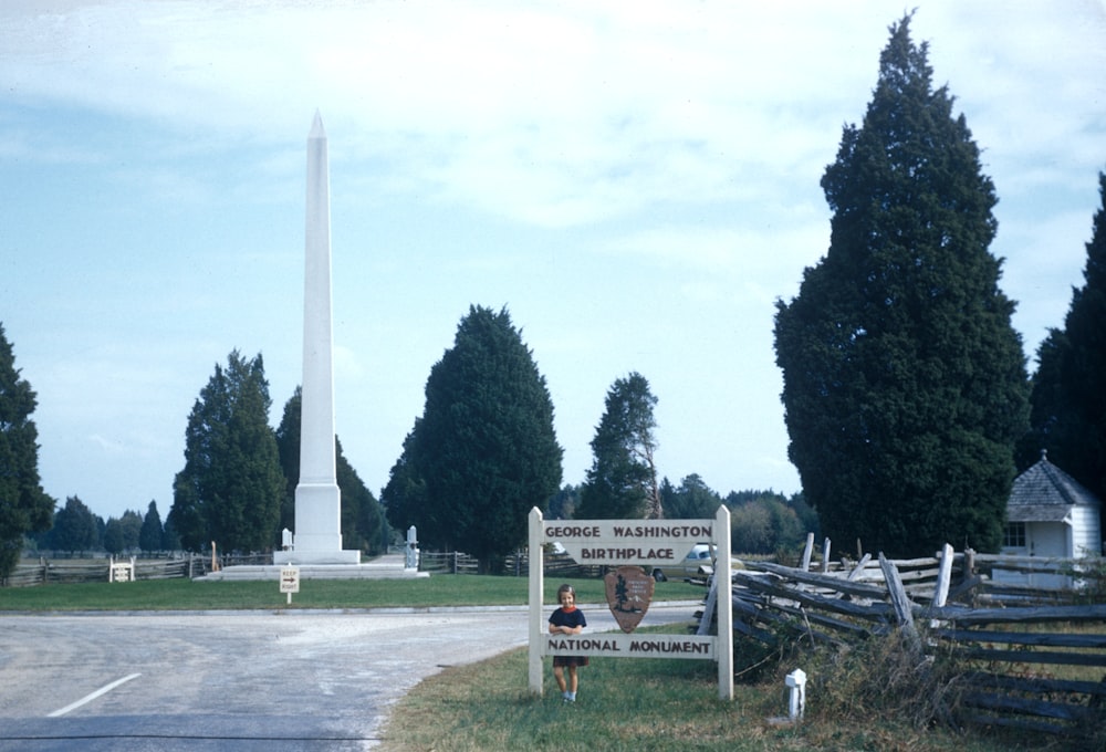 girl standing beside Washington National Monument