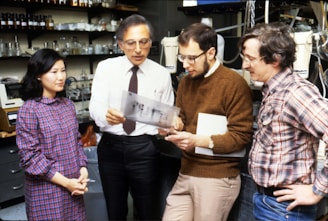 three men standing beside woman