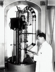 man standing infront of scientific machine