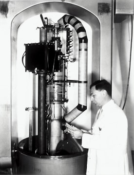 man standing infront of scientific machine
