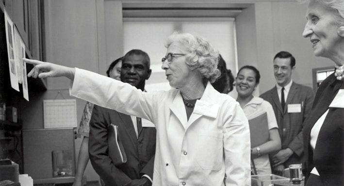 grayscale photo of doctors inside laboratory