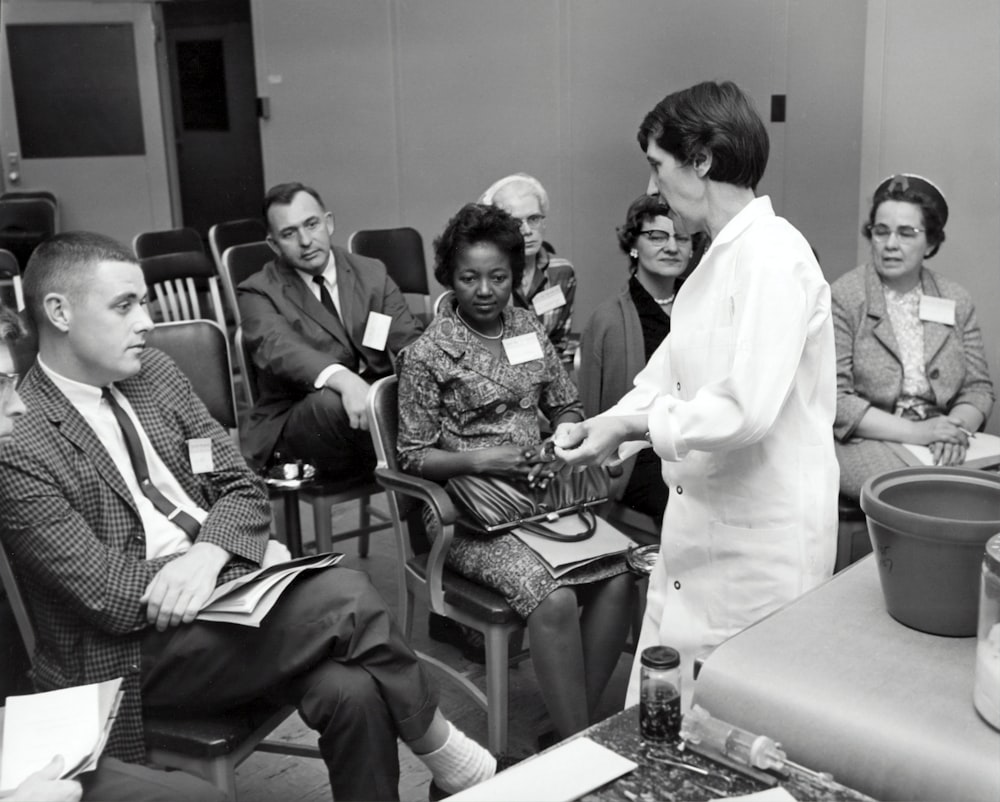 grayscale photo of people inside room