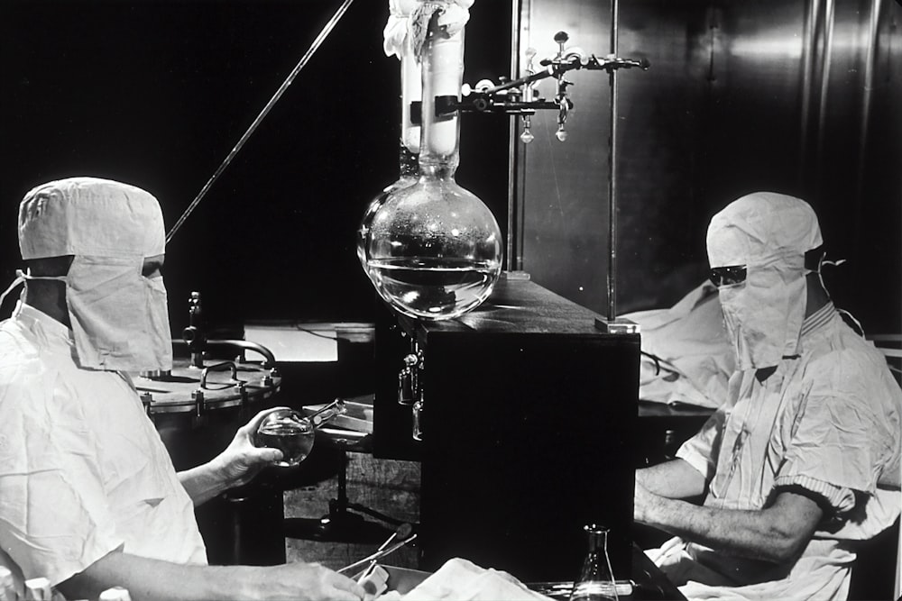 grayscale photo of people inside laboratory
