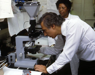 man using microscope