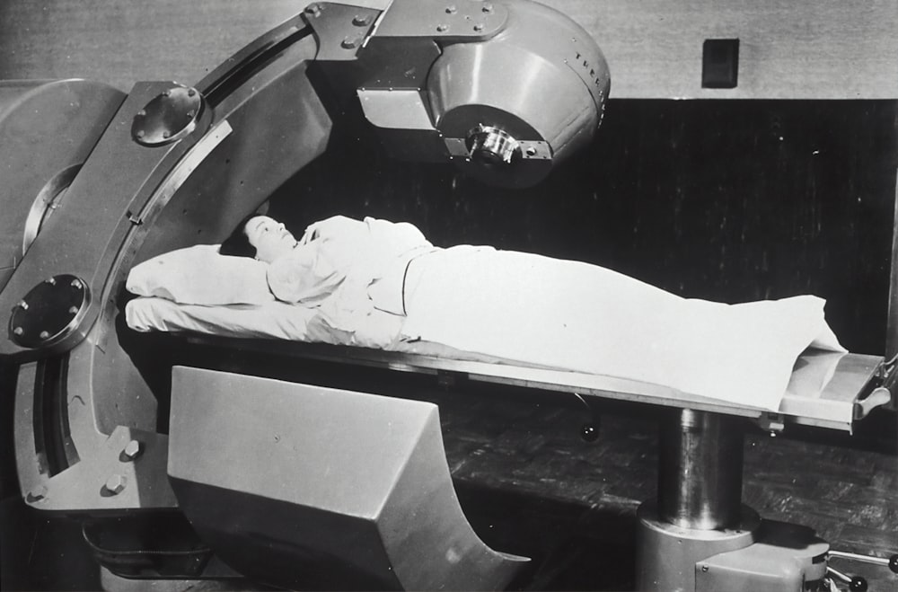 man lying on hospital machine