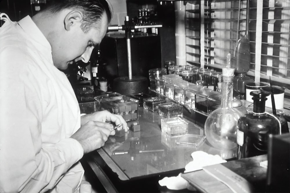 grayscale photo of man inside laboratory