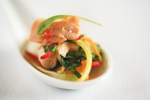 Close-up of gourmet salmon dish from Esencia Austral menu with fresh herbs