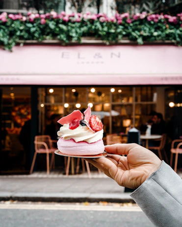 Artisanal hands gently whipping the chantilly, capturing the handmade craftsmanship in a warm Provence setting.