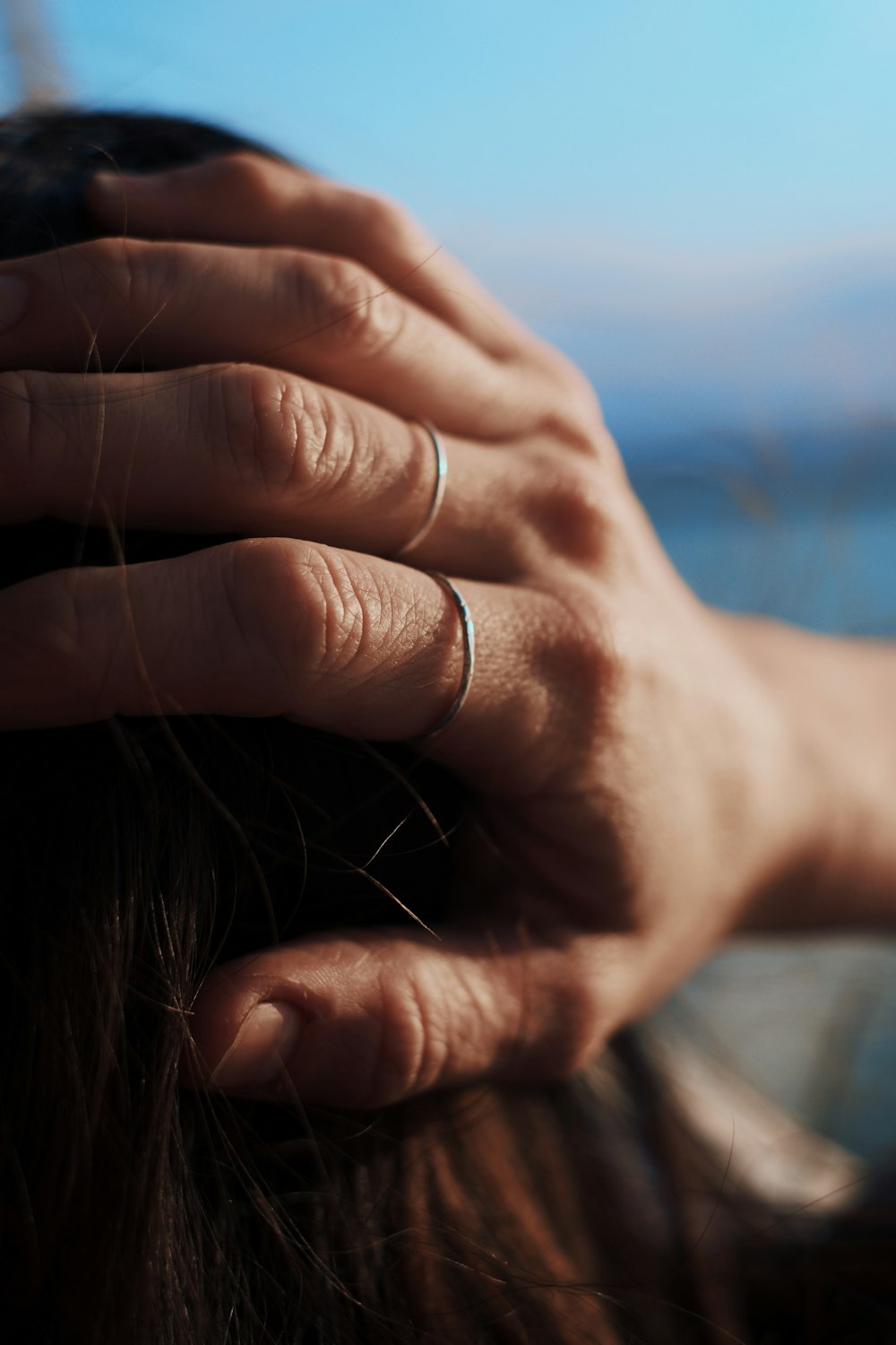 selective focus photo of woman holding hair