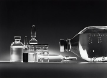 Minimalist display of pure peptide vials lined up on a sleek black tray.