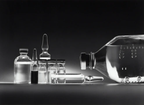 Sterile pharmaceutical bottles and blister packs arranged neatly on a clean surface, highlighting precision and safety.