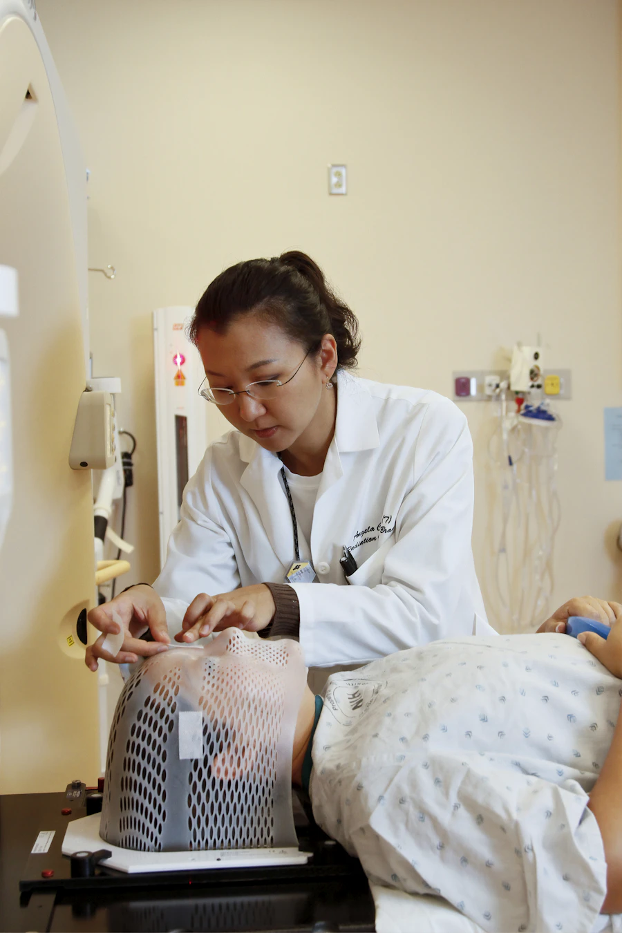 Nurse reviewing charts and reference material at a hospital station