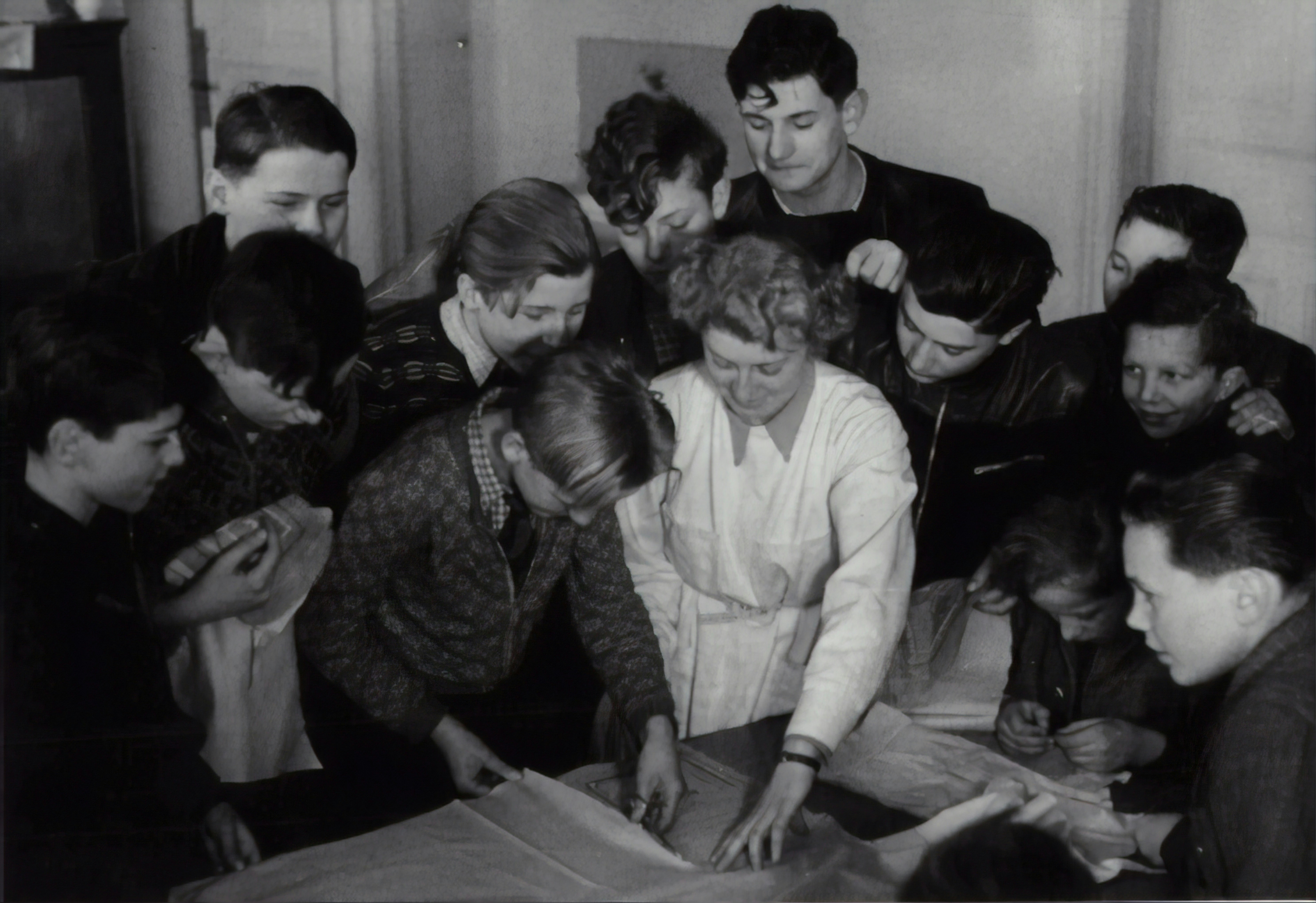 Boys learn to sew, darning and tailoring in the secondary school. 1952